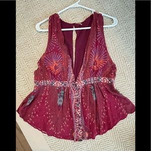 Free People top has a button front, simple vest styling, open back, rounded hem
